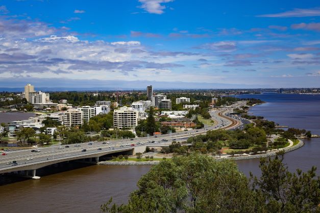 Daytime landscape view of Perth, Australia along highway and coastal line.
